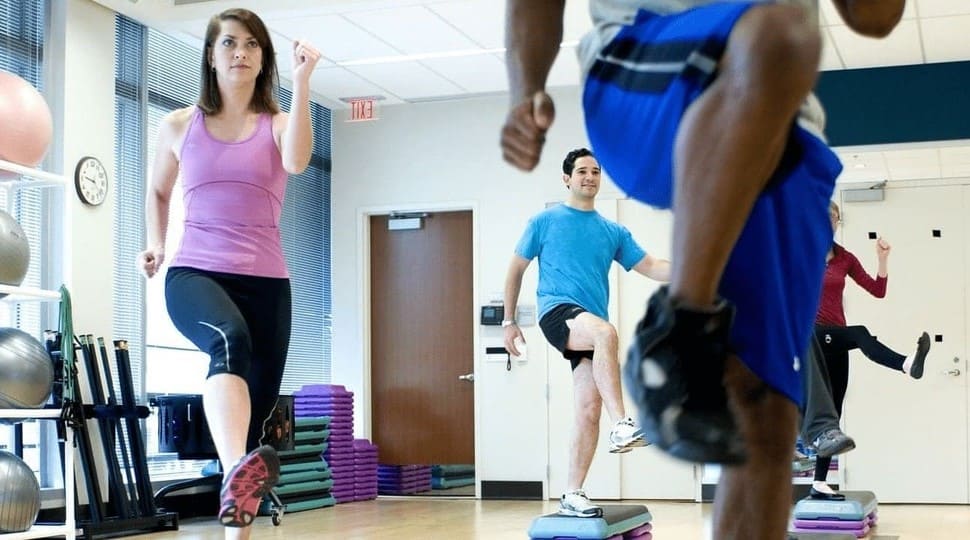 a group of happy people working out in a gym